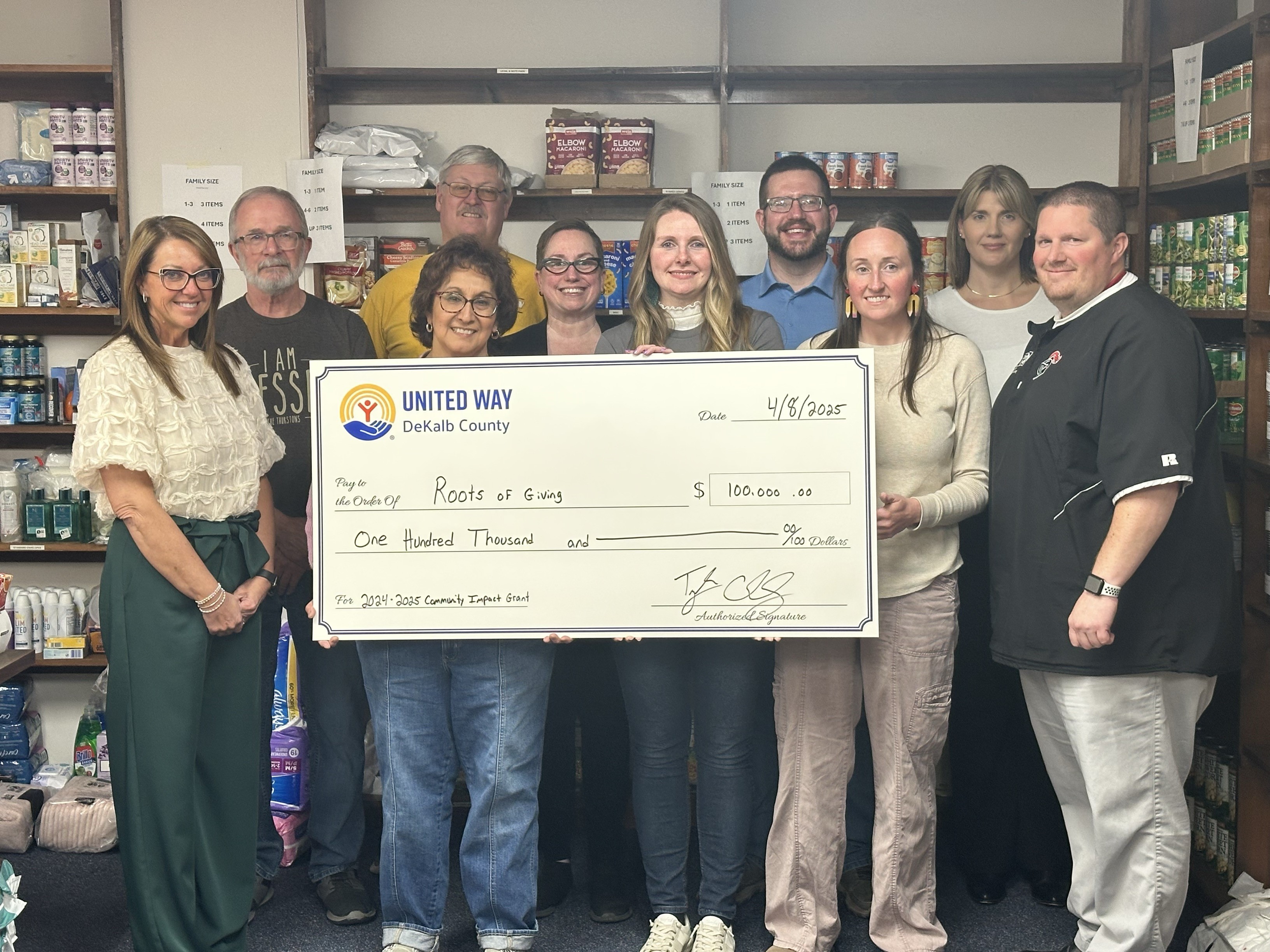 UWDC Presents check to Roots of Giving 